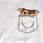 Immagine del prodotto Gremlins - T-shirt da donna bianca con Gizmo in tasca